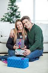 Image showing Loving Couple With Christmas Gifts At Home