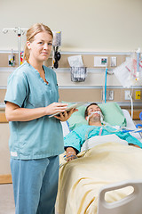 Image showing Nurse With Digital Tablet While Male Patient Resting On Bed