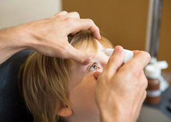 Image showing Optometrist Hands Putting Eye Drops In Patients Eye