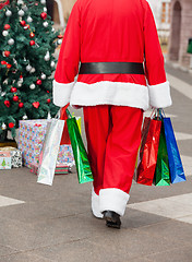 Image showing Santa Claus With Shopping Bags Walking In Courtyard