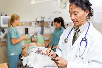 Image showing Doctor Writing Notes in Emergency