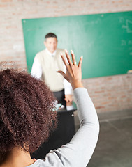 Image showing College Student Raising Hand To Answer In Classroom