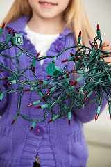 Image showing Girl Holding Tangled Fairy Lights