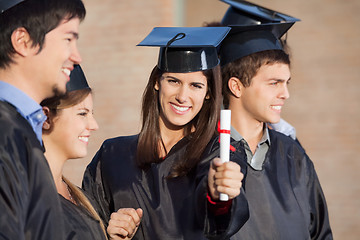 Image showing Student Showing Diploma While Standing With Friends At College