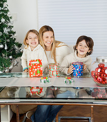 Image showing Happy Children And Mother With Christmas Presents