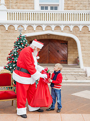 Image showing Boy Receiving Gift From Santa Claus