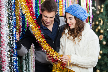 Image showing Couple Shopping For Tinsels At Store