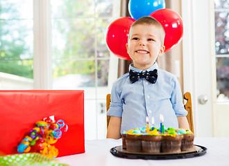 Image showing Birthday Boy With Cake And Present On Table