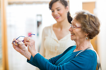 Image showing Senior Woman Holding New Glasses In Store