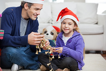 Image showing Girl With Father Holding Christmas Ornaments