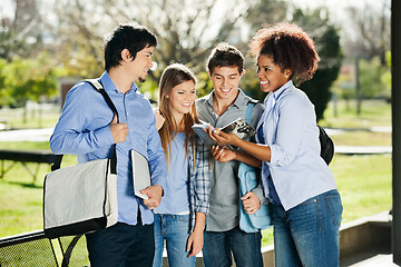 Image showing Students Discussing Over Book In University Campus