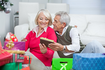 Image showing Senior Man Giving Christmas Gift To Woman