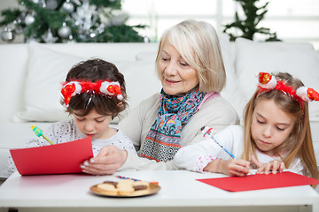 Image showing Senior Woman With Siblings Writing Letters To Santa Claus