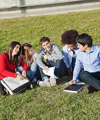 Image showing Happy Man With Classmates Sitting At College Campus