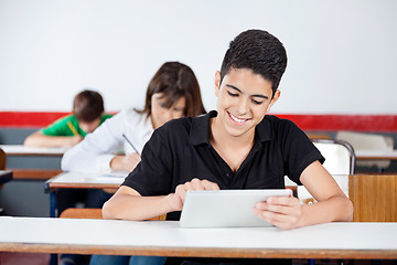 Image showing Teenage Schoolboy Using Digital Tablet At Desk