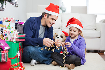 Image showing Girl And Father Holding Christmas Ornaments