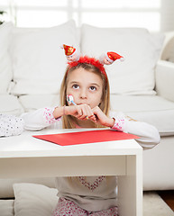 Image showing Girl Wearing Santa Headband With Pencil And Cardpaper