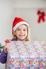 Image showing Happy Girl Holding Christmas Gift