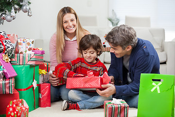 Image showing Woman With Boy And Man Opening Christmas Gift