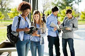 Image showing Students Reading Books In University Campus