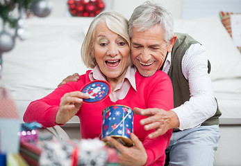 Image showing Surprised Senior Woman With Man Looking At Christmas Gift