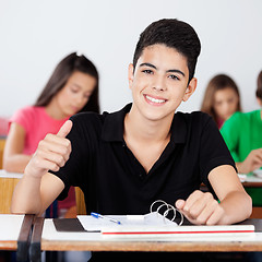 Image showing Teenage Schoolboy Gesturing Thumbs Up In Classroom