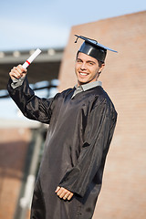 Image showing Male Student Holding Diploma On Graduation Day At Campus