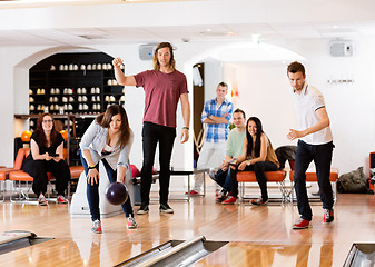 Image showing Man And Woman Bowling With Friends in Background