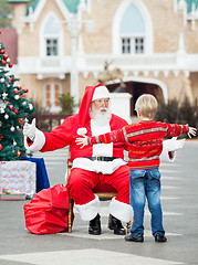 Image showing Boy About To Embrace Santa Claus