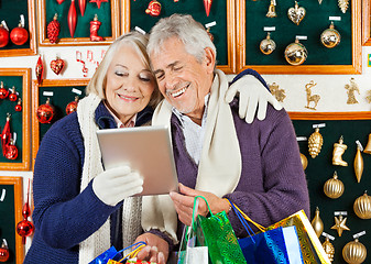 Image showing Happy Couple Using Digital Tablet At Christmas Store