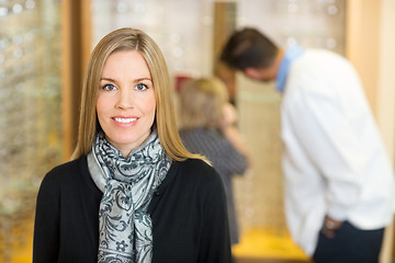 Image showing Smiling Woman With Optometrist And Son In Background