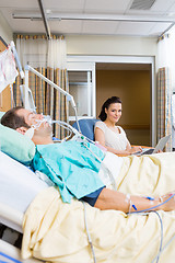 Image showing Woman With Laptop Sitting By Patient In Hospital