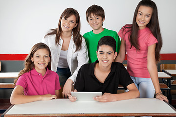 Image showing Portrait Of Teenage Students Using Tablet At Desk