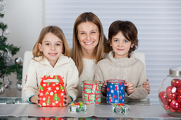 Image showing Mother And Children With Christmas Presents