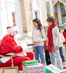 Image showing Children Taking Biscuits From Santa Claus