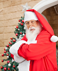 Image showing Santa Clause Standing Arms Crossed Outside House