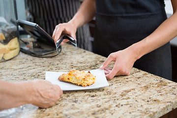 Image showing Waitress Serving Sweet Food To Woman