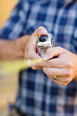 Image showing Carpenter Holding Tape Measure