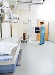 Image showing Female Nurse Adjusting Xray Film In Machine