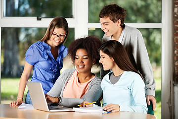 Image showing University Students Using Laptop At Desk In Classroom