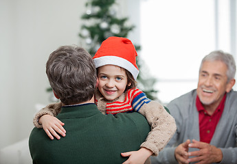 Image showing Happy Boy Embracing Father During Christmas