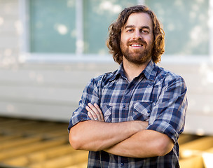 Image showing Mid Adult Carpenter With Arms Crossed Standing At Construction S