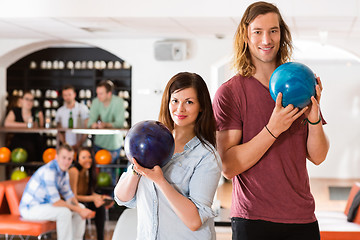 Image showing Man And Woman Holding Bowling Balls in Club