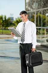 Image showing Professor Reading Book While Standing On College