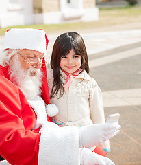 Image showing Girl With Santa Claus Using Smartphone