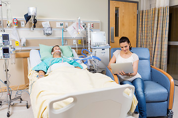 Image showing Woman With Digital Tablet Sitting By Patient