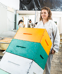 Image showing Beekeeper Pushing Trolley Of Stacked Honeycomb Crates