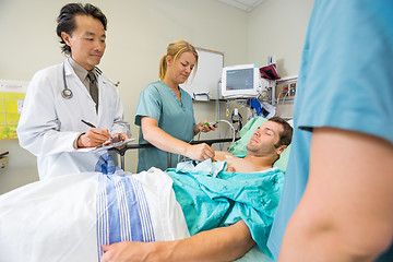 Image showing Patient Being Examined By Doctors In Hospital