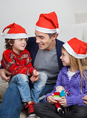 Image showing Father And Children In Santa Hats