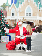 Image showing Santa Claus About To Embrace Girl